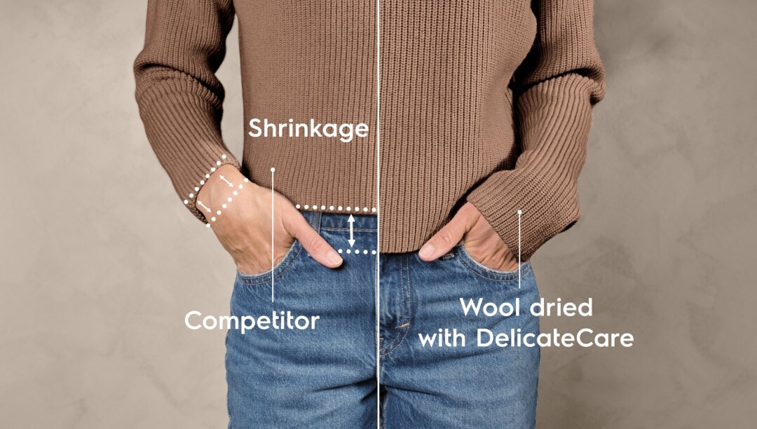 Nærbilde av en kvinne i en beige genser og jeans.