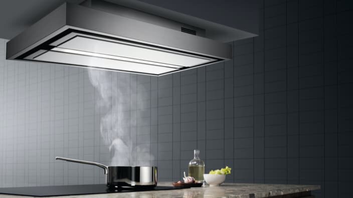 Takmontert ventilator over en rykende panne